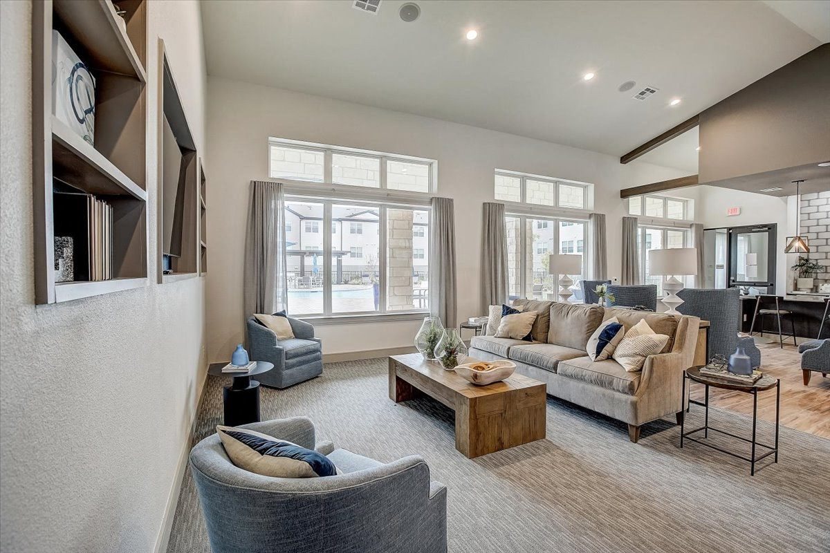 Skyview North clubhouse lounge with high ceilings, conversational seating, and large windows to the pool.